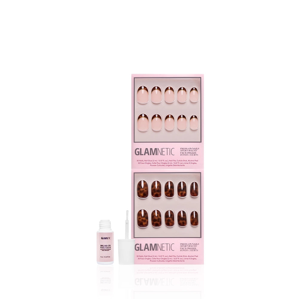 Two sets of glamnetic The Short Round Tortoiseshell Duo press-on nails in pink boxes, with a small nail glue bottle and open brush displayed in front, arranged against a white background. - Product image
