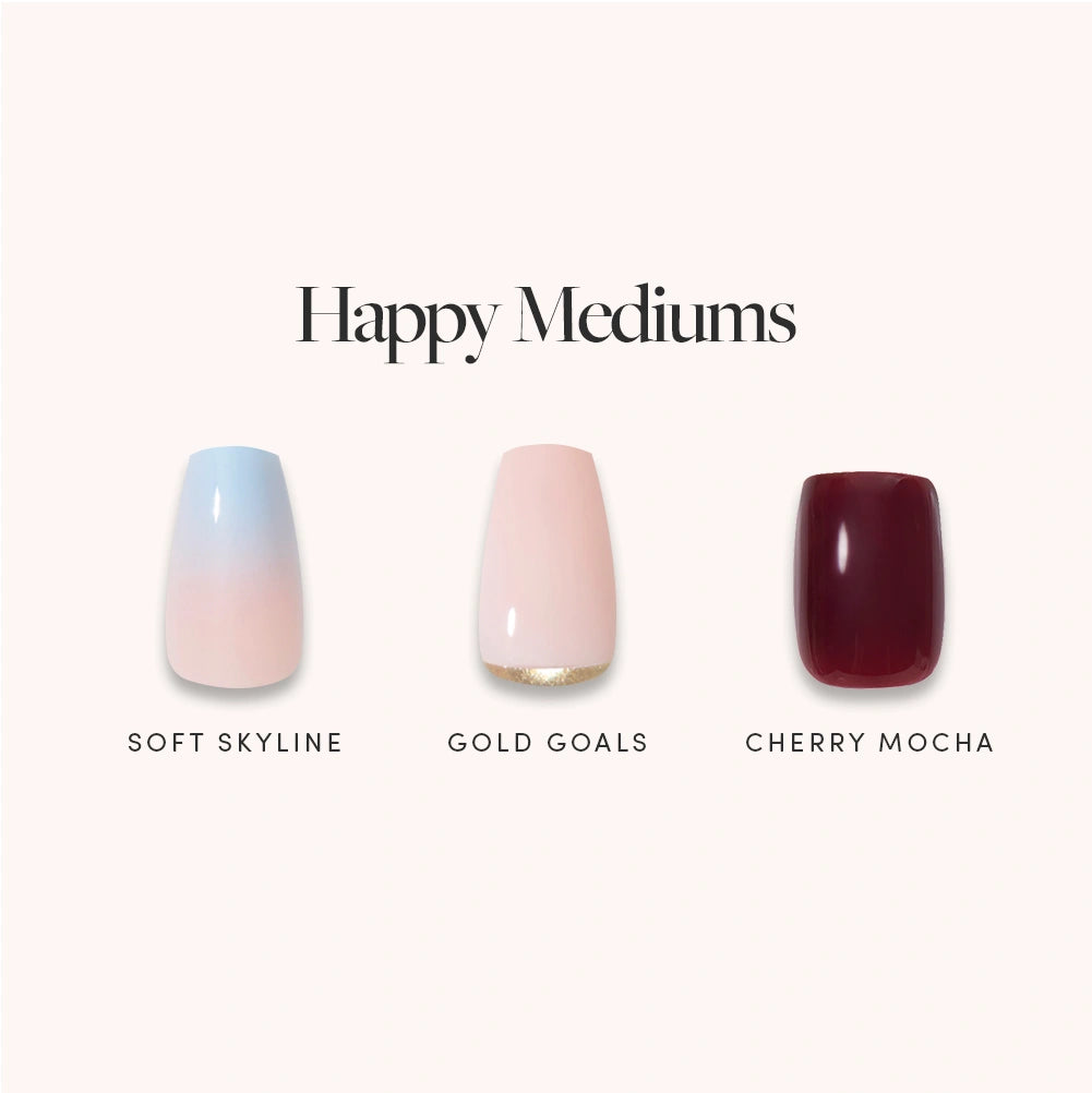 Three artificial nails from glamnetic are shown in the shades: Soft Skyline (light blue ombre), Gold Goals (pale pink with gold glitter tip), and Cherry Mocha (deep burgundy), beneath the text “Happy Mediums.” Get salon-quality nails at home with this medium coffin press-on nail set from glamnetic. - Product image