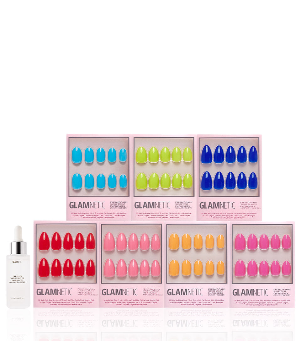 Seven boxes of glamnetic’s Summer Vivids Collection press-on nails in bold colors are arranged in two rows, each box showing the glamnetic logo. A white dropper bottle is placed to the left of the display. - Product image