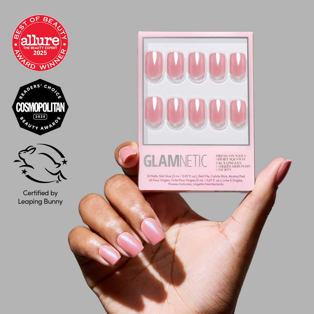 A hand with glossy, natural-looking mauve pink nails holds a glamnetic Mauve On Up vegan press-on nails box. Allure and Cosmopolitan awards plus Leaping Bunny cruelty-free certification are displayed on the left.