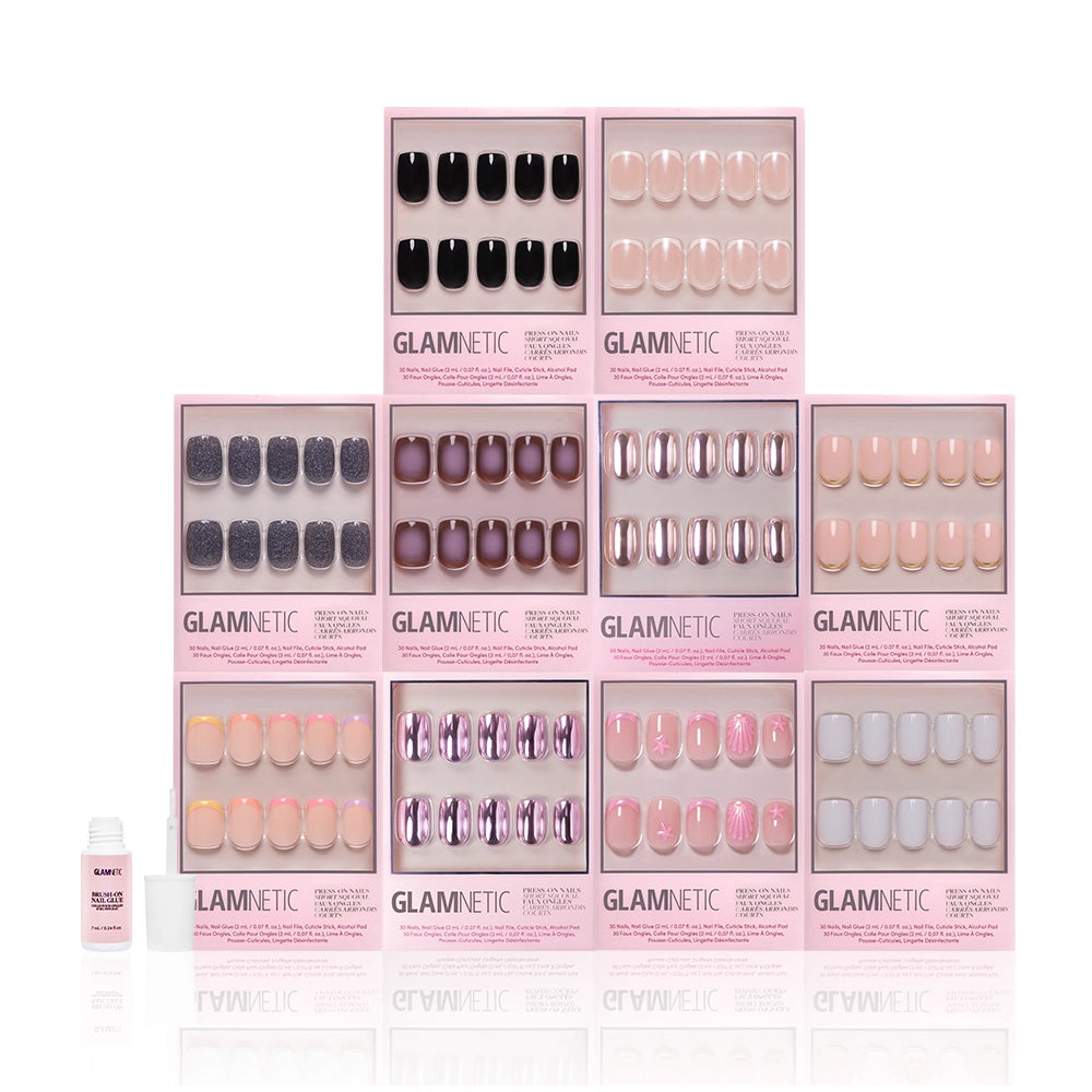 Ten sets of glamnetic's The Squoval Vault press-on nails, featuring trendy French tip and short squoval styles, are arranged in a pyramid with a small nail glue bottle on the left, all set against a white background. - Product image