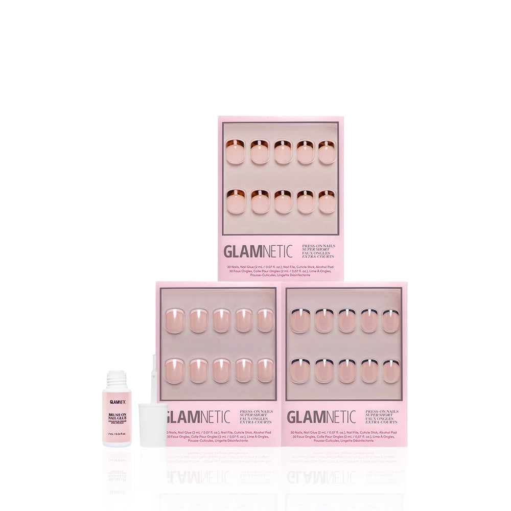 Three boxes of glamnetic The Super Short Frenchies press-on nails are pyramid-stacked in front of a white background, with a small nail glue bottle and cap placed in front. - Product image