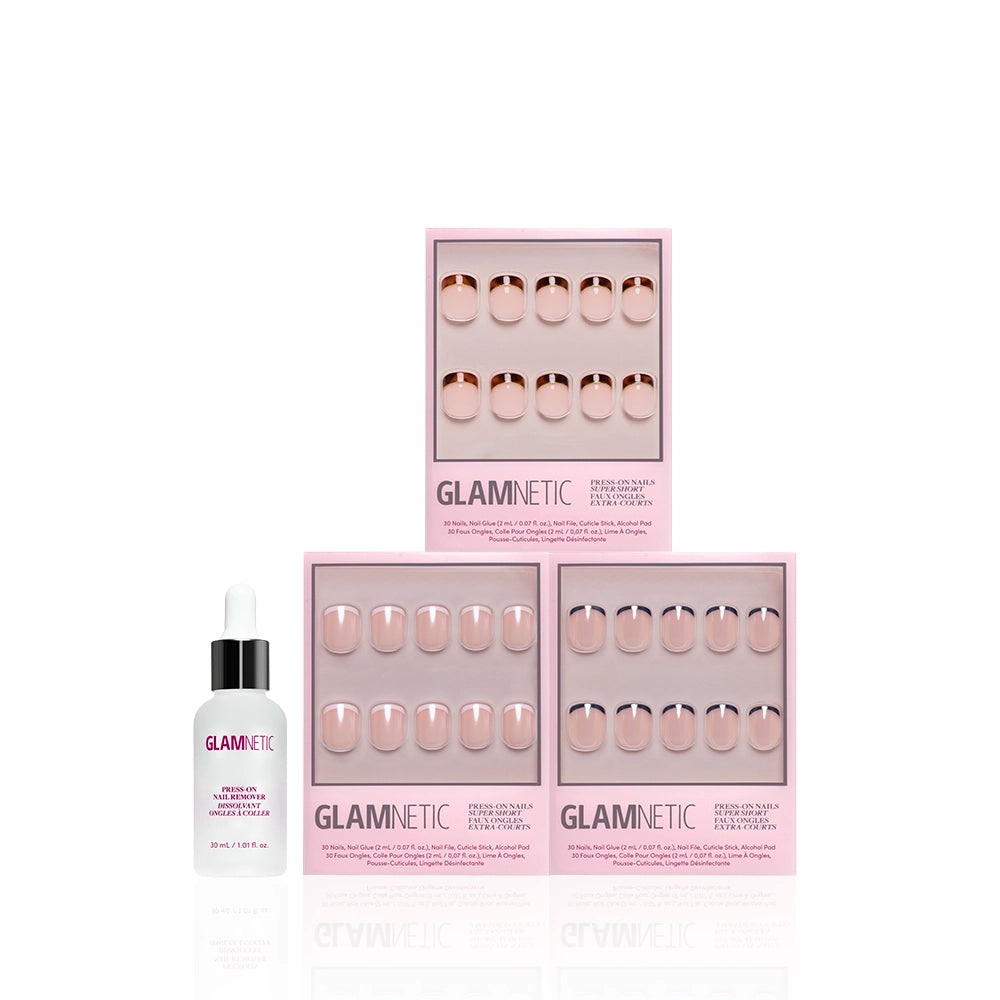Three pink boxes of glamnetic press-on nails, including The Super Short Frenchies set, are arranged in a triangle with a glamnetic nail glue bottle in front. The sleek packaging pops against the white background. - Product image
