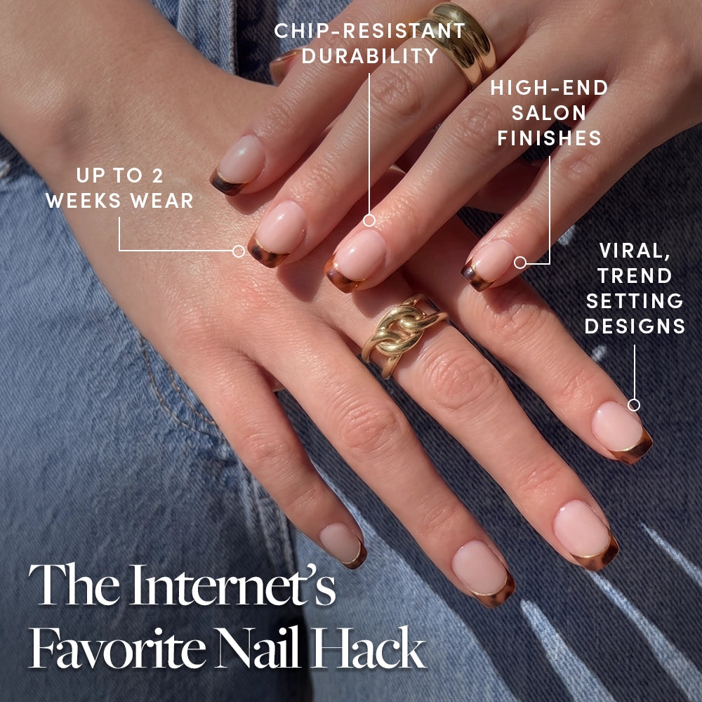 Close-up of hands wearing glamnetic's The Trendsetter nails in chic brown tortoiseshell French tips, gold rings, and callouts: chip-resistant durability, up to 2 weeks wear, salon finish, viral design. Text: The Internet’s Favorite Nail Hack. - Product image
