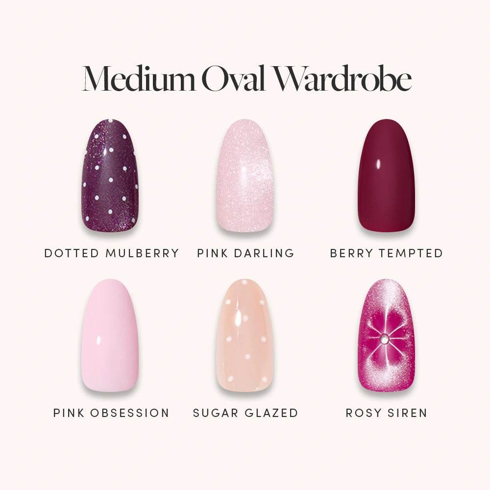 Six medium oval-shaped, salon-quality press-on nails from glamnetic’s “Medium Oval Wardrobe” collection—Dotted Mulberry, Pink Darling, Berry Tempted, Pink Obsession, Sugar Glazed, and Rosy Siren—are beautifully displayed on a light background in a variety of colors and designs. - Product image