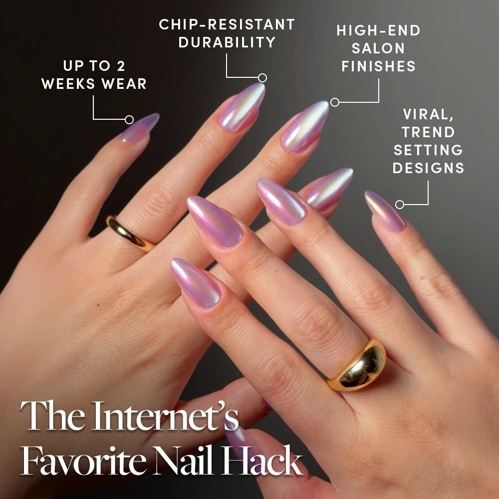 Two hands with long, iridescent pink pearlescent nails in "Timeless Oyster" by glamnetic are shown. Gold rings adorn the fingers. Text highlights up to 2 weeks’ wear, chip-resistant durability, salon finish, and viral trendy designs. - Product image