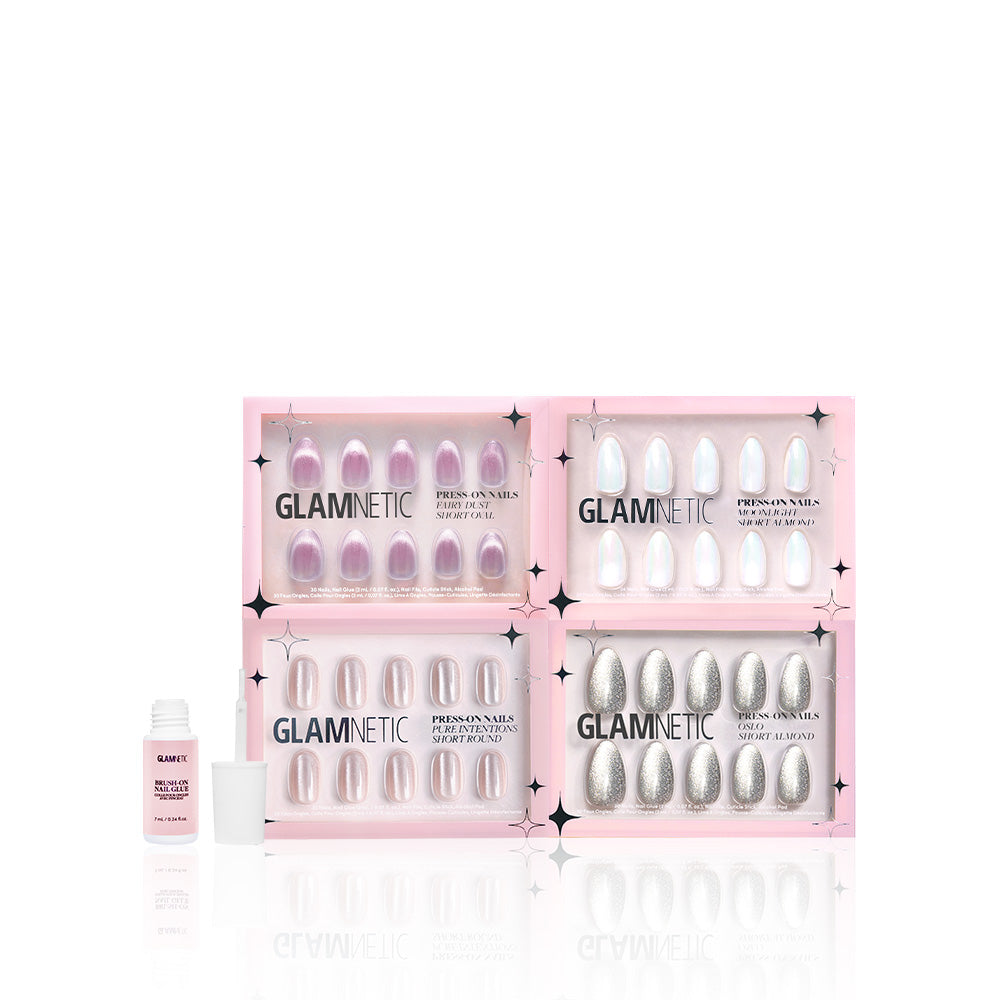 Four boxes of glamnetic To the Stars press-on nails are displayed with a small bottle of pink nail glue in front, all set against a white background. - Product image