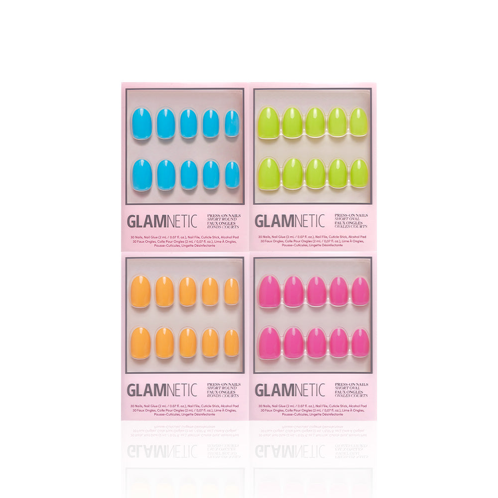 The glamnetic Tropic Like Its Hot set includes four press-on nail boxes, each with 10 nails in solid blue, green, orange, and pink. The collection comes in a stylish pink rectangular package with labeled compartments. - Product image
