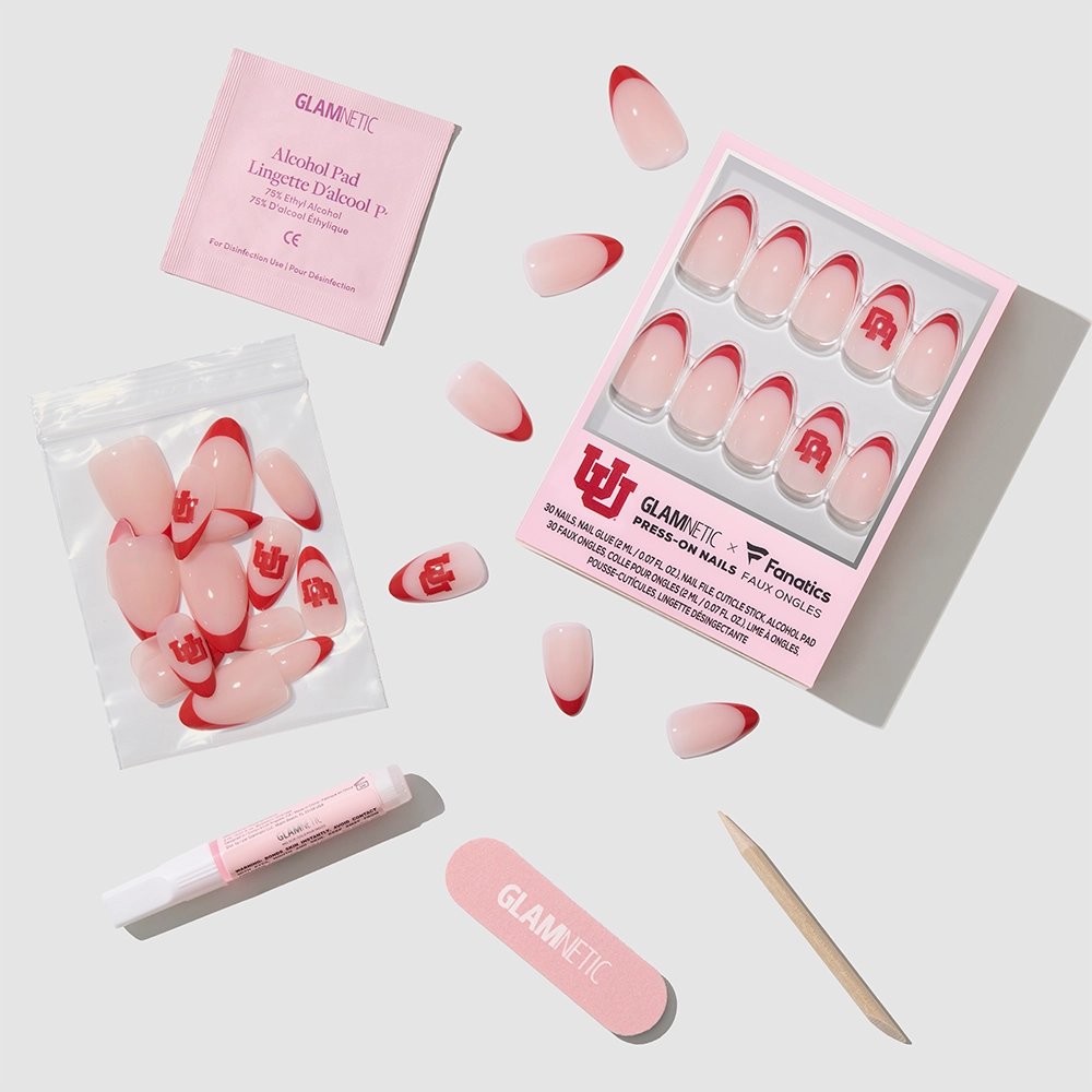 The glamnetic Utah Utes Press-On Nail Set includes red French tip nails with U and R letters, nail glue, a file, a wooden stick, an alcohol pad, and extra salon-quality nails arranged on a white background. - Product image