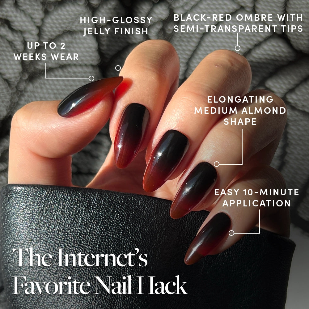 A hand shows off glossy, almond-shaped black-red ombre nails from the glamnetic Vampiress Press-On Nail Set, featuring a jelly finish, semi-transparent tips, up to 2 weeks of wear, and a quick 10-minute application for salon-quality results. Text reads: The Internet’s Favorite Nail Hack. - Product image