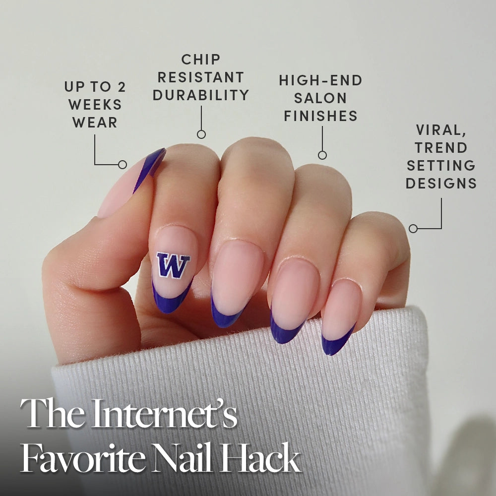 A hand with long, almond-shaped nails from glamnetic's Washington Huskies Press-On Nail Set, featuring a purple French tip and W accent. Up to 2 weeks wear, chip-resistant, high-end finish—trendy game day nails and the Internet’s Favorite Nail Hack. - Product image