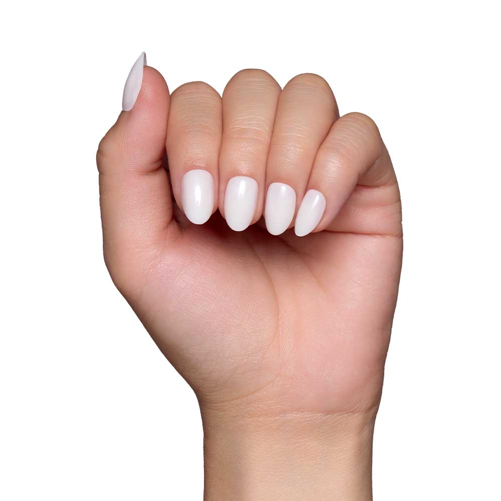 A hand with short oval nails, featuring a glossy finish and painted with the White Swan nail set by glamnetic, is displayed against a plain white background. - Product image