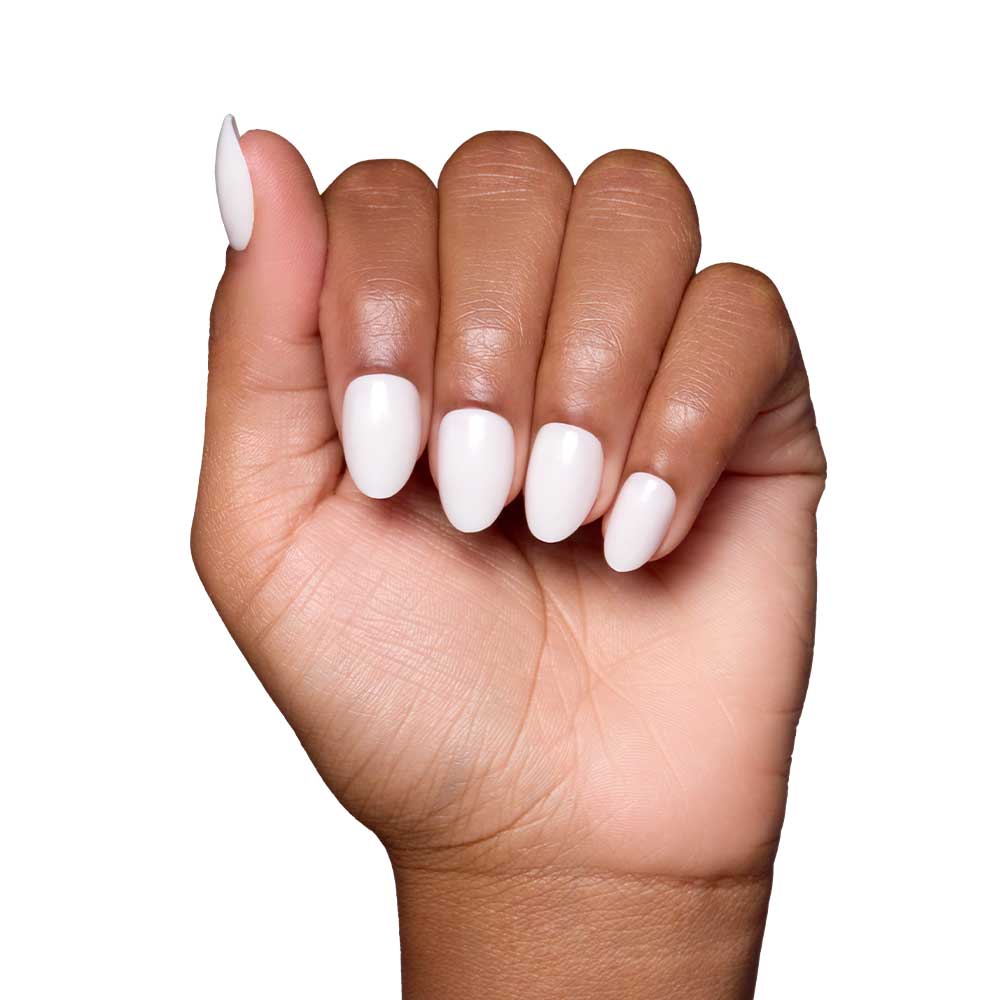 A hand with medium brown skin displays glamnetic’s White Swan nails, featuring a glossy finish and a rounded almond shape, set against a plain white background. - Product image
