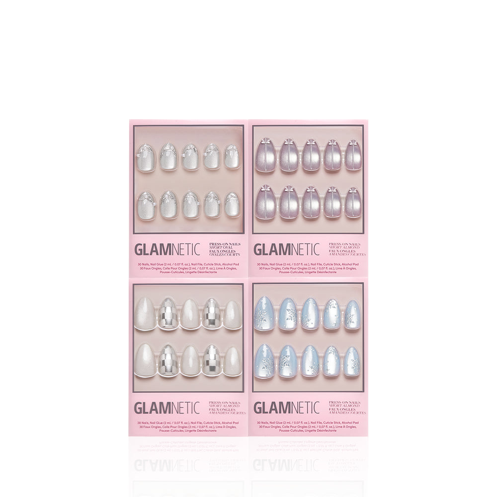 Four boxed sets of glamnetic Winter Village press-on nails in assorted designs and colors, arranged in a square on a white background. Each pink-branded box contains ten nails, providing an easy salon-quality manicure at home—ideal for creating your own winter nail bundle. - Product image