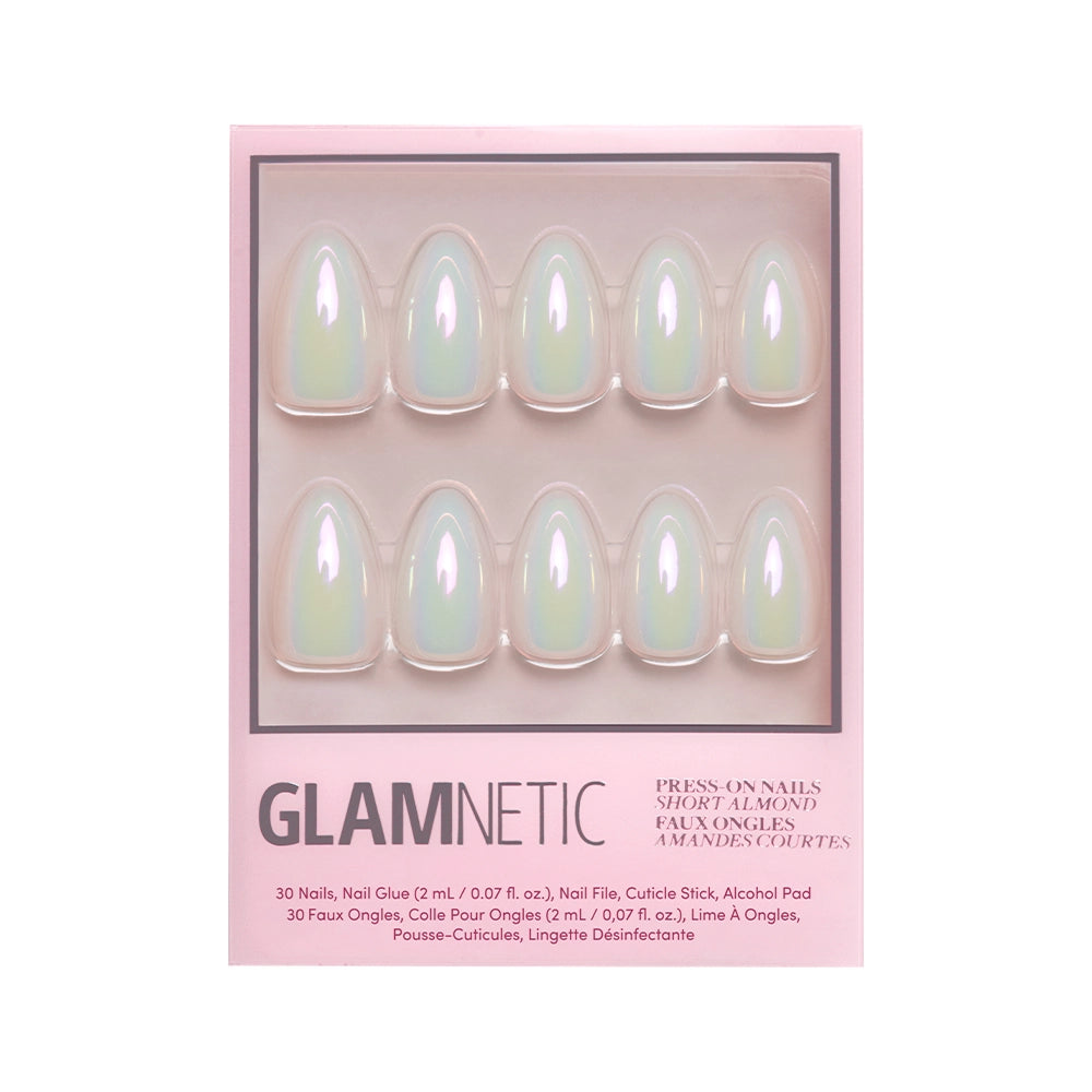 A pink glamnetic box contains the Entranced Nail Set—short, almond-shaped nails with an iridescent holographic finish, neatly arranged in two rows, along with nail glue and manicure tools included in the packaging.