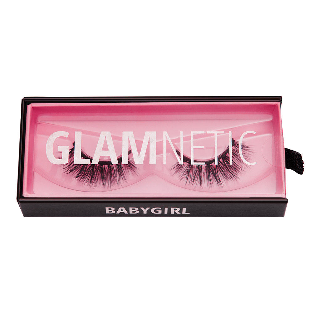 A box of glamnetic Babygirl reusable lashes with Babygirl in white text, a pink interior, and a clear lid that displays GLAMNETIC over vegan lashes. - Product image