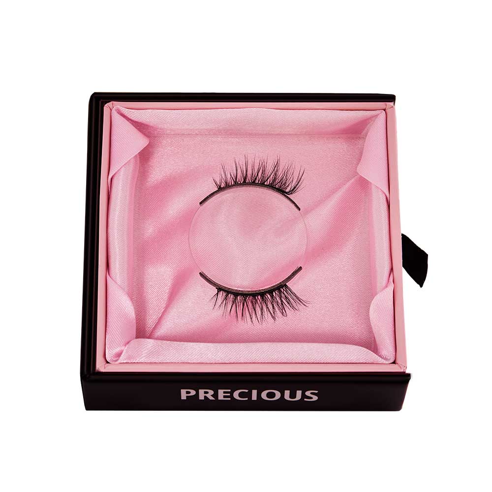 A pair of cat-eye false eyelashes by glamnetic, named Precious, displayed in a square black box lined with pink satin, with PRECIOUS printed in white on the front. - Product image