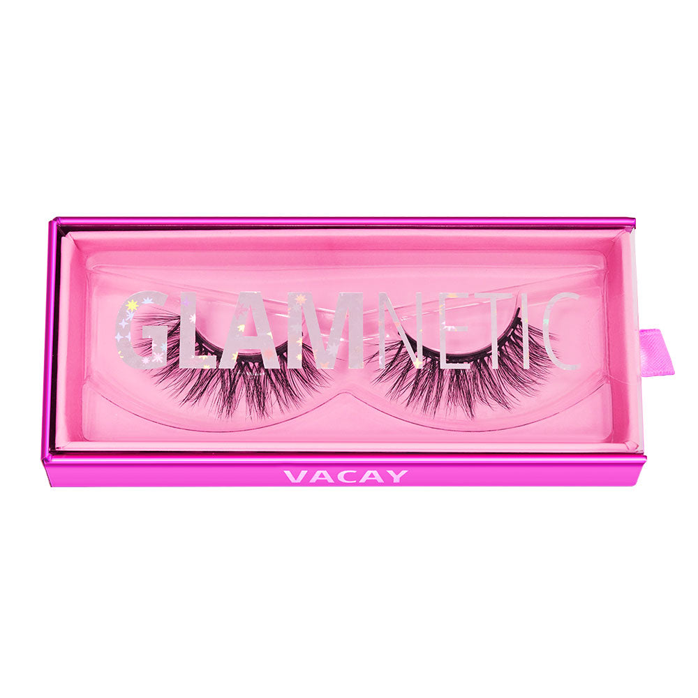 A pair of vegan-friendly, magnetic lashes called Vacay by glamnetic, packaged in a clear plastic case with a bright pink border and featuring the brand and product names on the packaging. - Product image