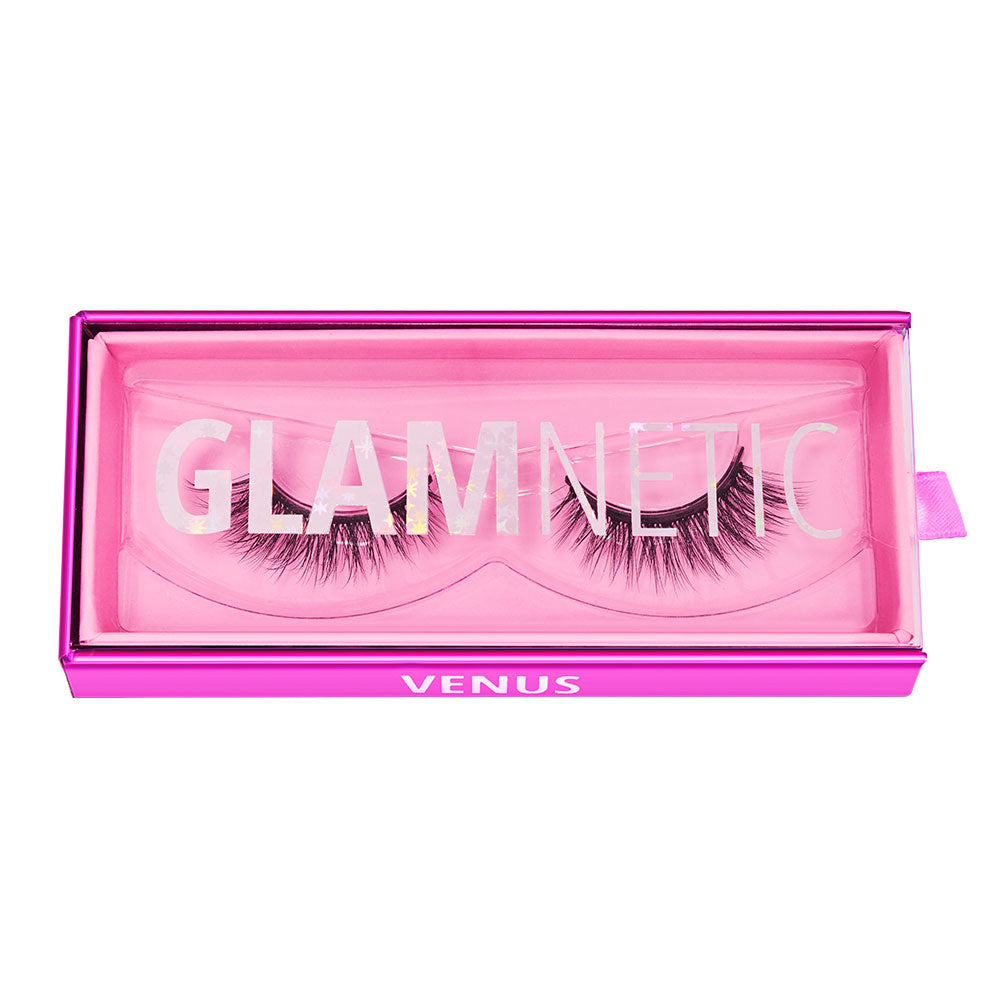 A pair of vegan-friendly Venus lashes by glamnetic in a pink rectangular magnetic case with GLAMNETIC on the clear lid, VENUS on the front edge, and a small pink tab on the right side. - Product image